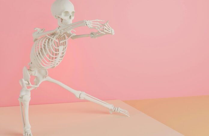 Photo by dada_design a skeleton is dancing on a pink background
