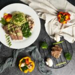 하루 한 끼, 식사 줄이기 열풍… 건강하게 따라하는 법 a white plate topped with meat and veggies