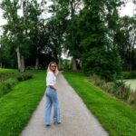 변화하는 정신건강 관리, 일상 속 작은 루틴이 해답 woman in white long sleeve shirt and blue denim jeans standing on gray asphalt road during